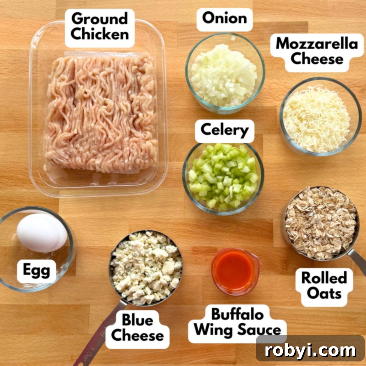 Ingredients for buffalo chicken meatloaf: ground chicken, onion, mozzarella cheese, celery, egg, blue cheese, buffalo wing sauce, and rolled oats.
