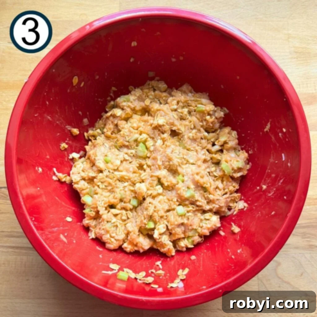 Ground chicken added to the other ingredients to form buffalo meatloaf mixture.