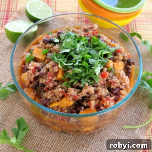 Large serving bowl overflowing with Sweet Potato Black Bean Chili, generously topped with fresh cilantro.