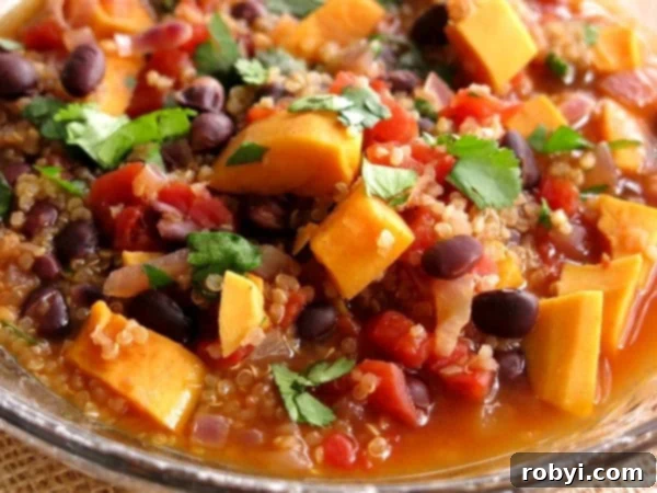 Close-up shot of the chili, showcasing the black beans, tender sweet potato cubes, and cooked quinoa.