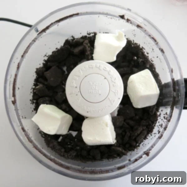 Oreos and cream cheese in a food processor.
