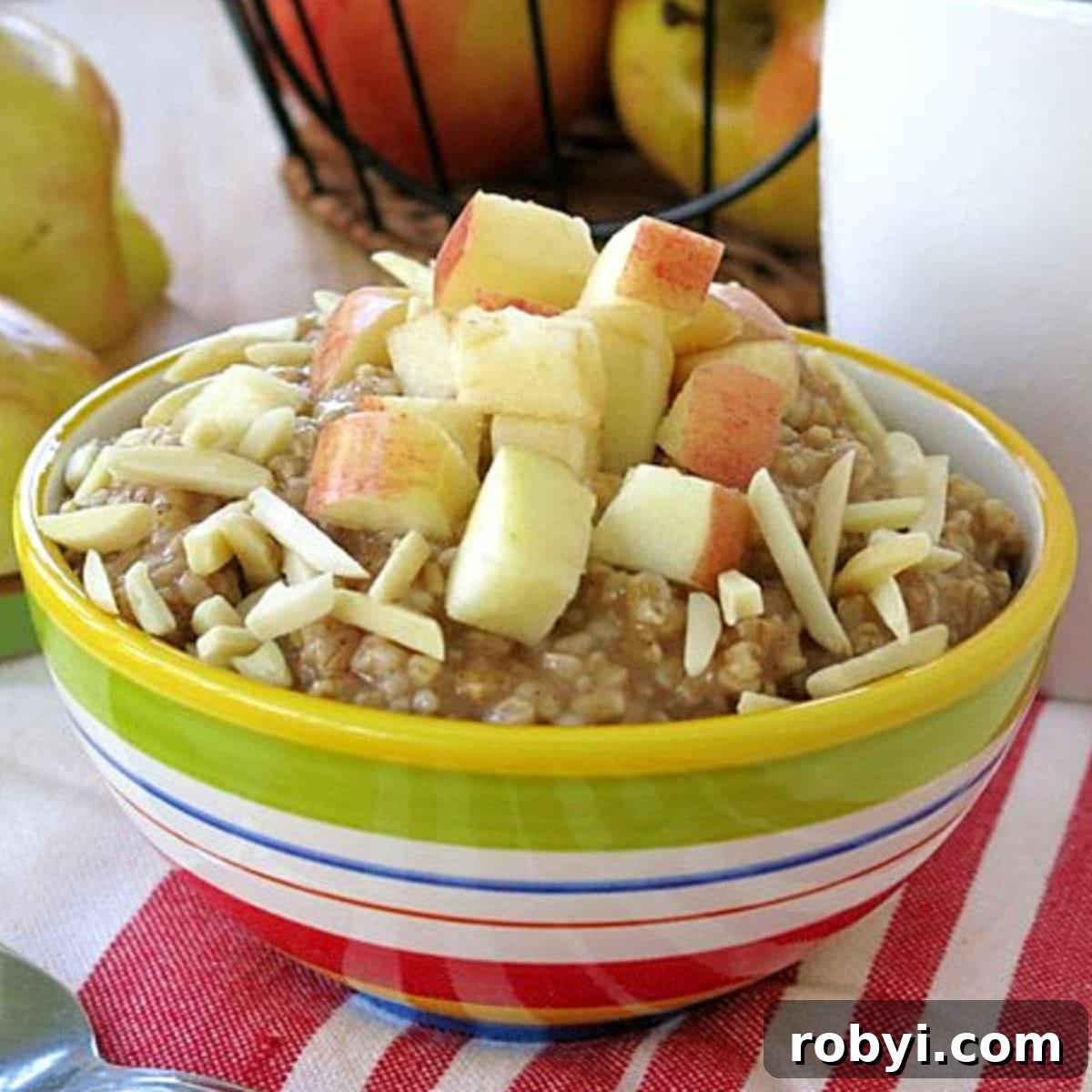 Bowl of slow cooker steel cut oatmeal in a bowl topped with apples and almonds.