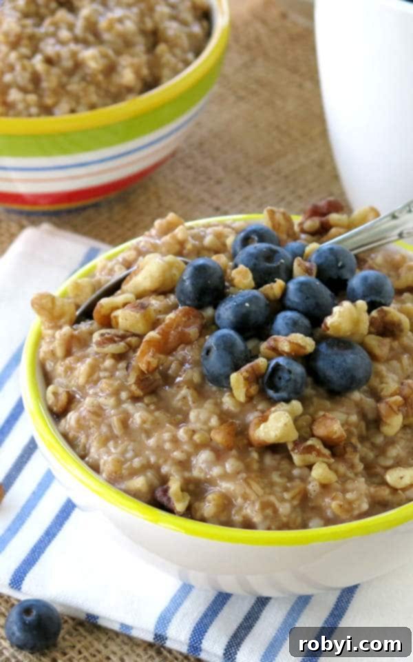 Bowl of steel cut oatmeal cooked in a Crock Pot topped with blueberries and walnuts.