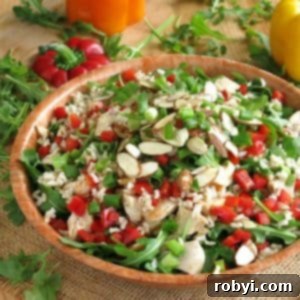 Chicken Arugula Salad with Rice and sesame dressing in a bowl