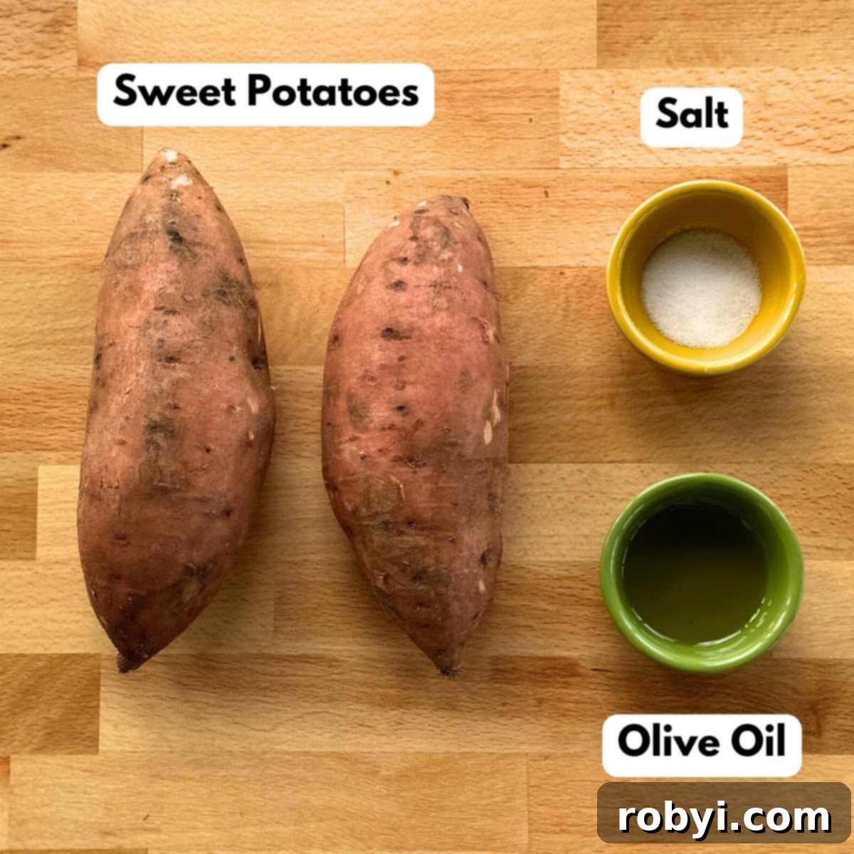 Ingredients for crispy sweet potato chips laid out: two vibrant sweet potatoes, a bottle of olive oil, and a small pile of sea salt.
