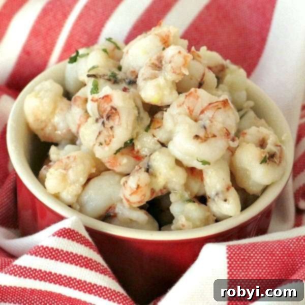 Sauteed Rock Shrimp Recipe in a bowl, glistening with lemon garlic butter sauce.