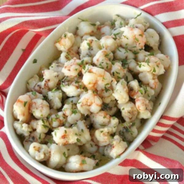 Lemon Garlic Butter Rock Shrimp in a serving bowl, garnished with fresh parsley.
