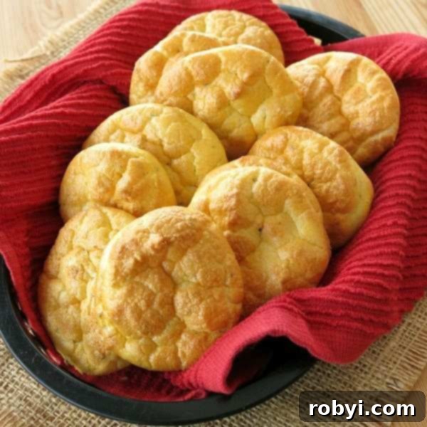 A close-up shot of a perfect Keto Cloud Bread round, golden and fluffy, highlighting its irresistible texture.