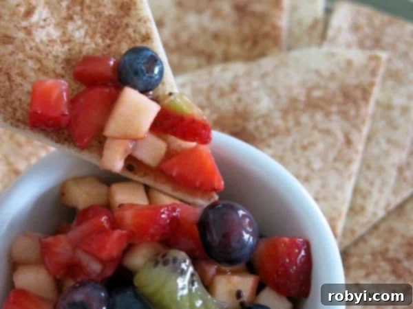 Cinnamon Chip dipping into bowl with Fruit Salsa
