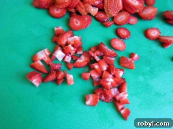 Diced strawberries on a cutting board