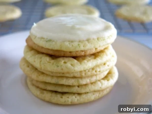 Key Lime Cookies with Key Lime Icing stacked on a plate.