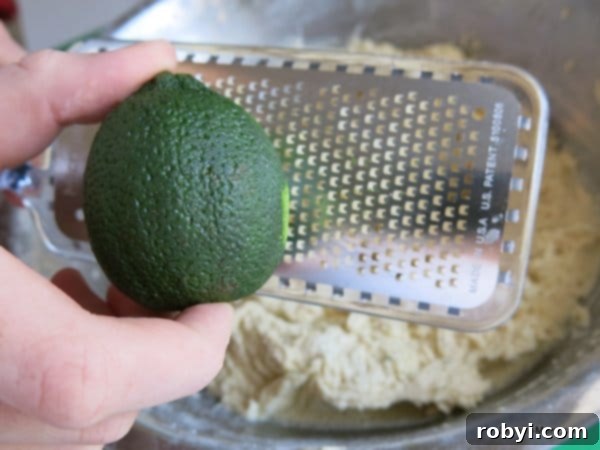 Lime being zested into a bowl