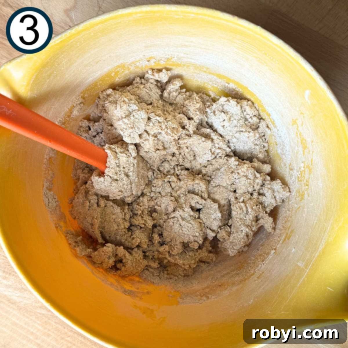 Whisked eggs, Greek yogurt, and vanilla extract combined with dry ingredients just until moistened.