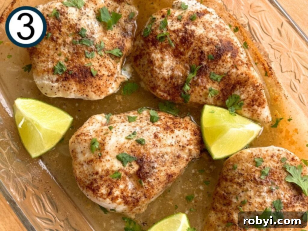 Baked chili lime chicken in a glass dish with melted butter and juices.