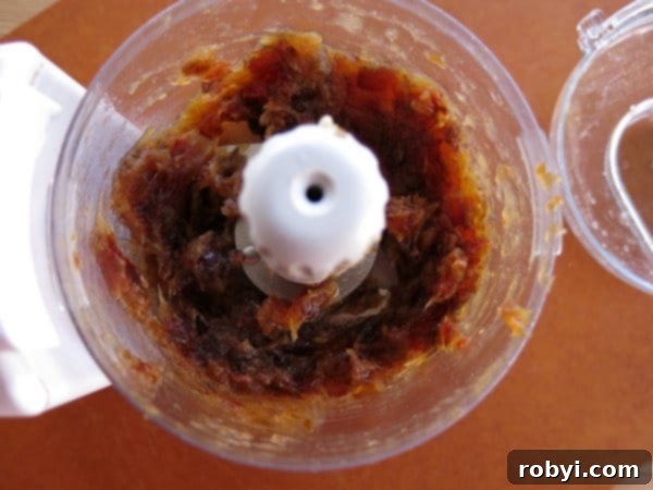 Effortless Vegan Chocolate Date Truffles 3 Smooth Medjool date paste in a food processor, ready for the recipe.