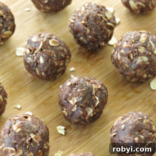 Effortless Vegan Chocolate Date Truffles 4 Close-up of no-bake date balls on a cutting board, ready to be enjoyed.