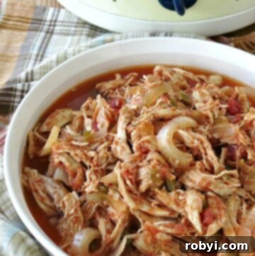 Healthy Salsa Chicken in serving dish with crock-pot in the background