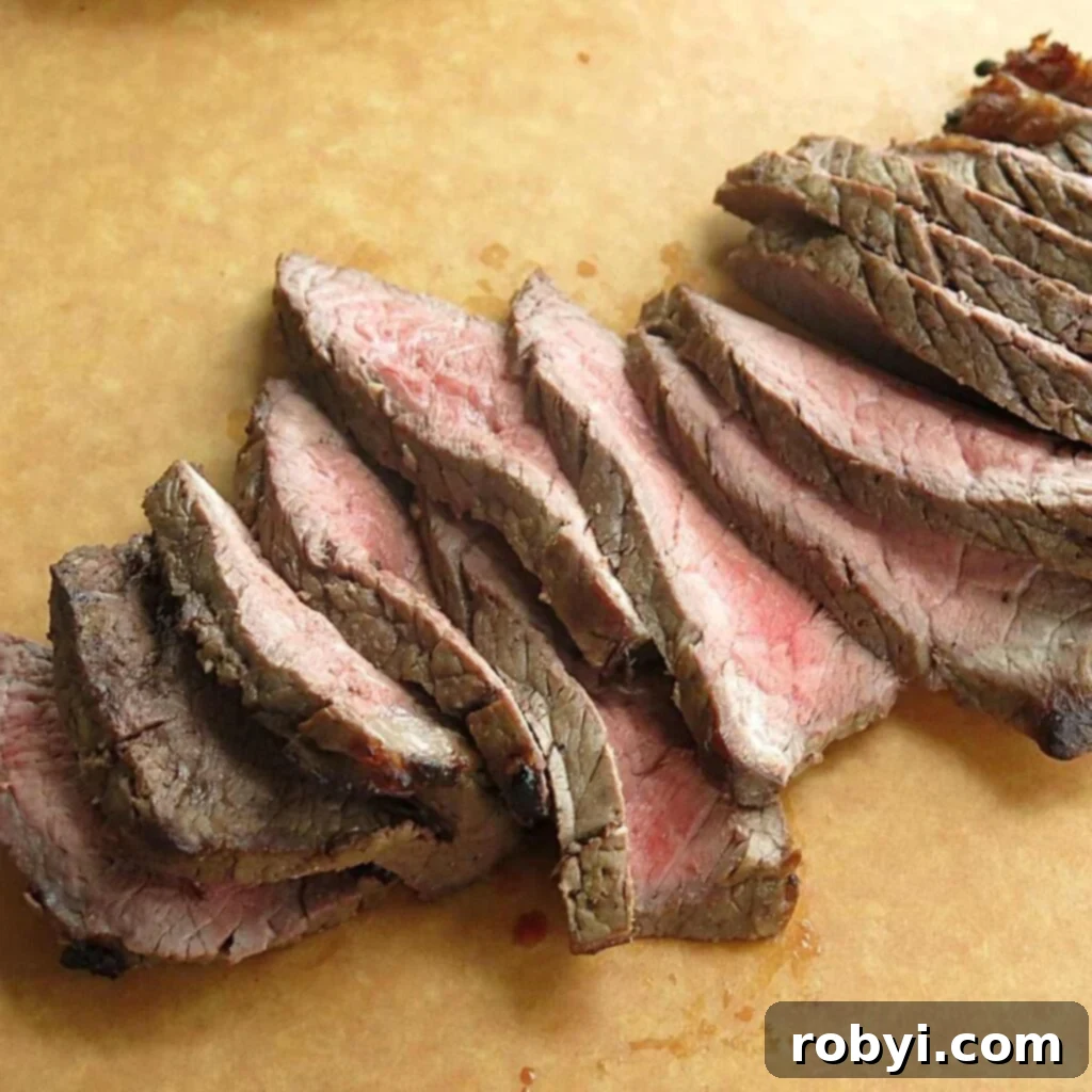 The Ultimate Oven-Baked London Broil 2 Perfectly cooked London Broil, tender and juicy, sliced and ready to serve.