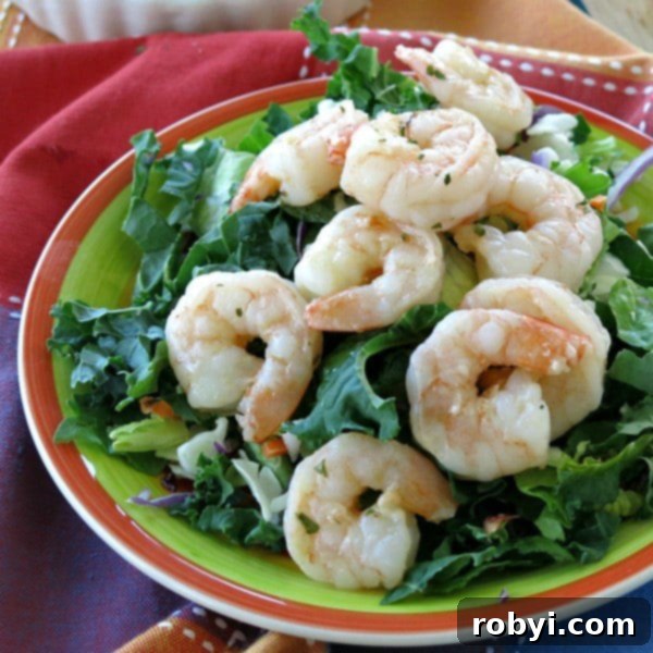 Skillet shrimp beautifully arranged on a bed of fresh mixed greens, perfect for a light and healthy meal.