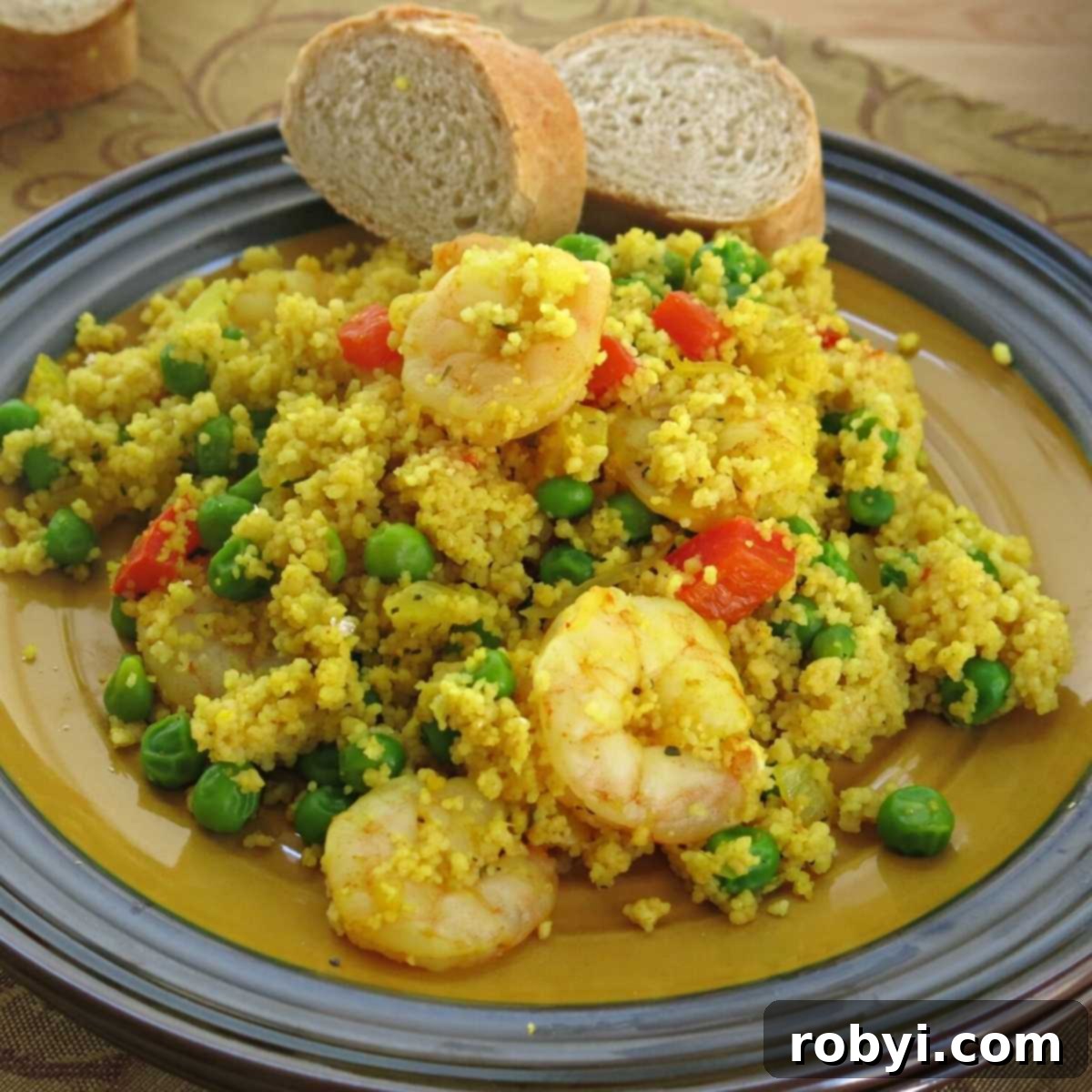 Vibrant Shrimp Couscous Paella with tender peas and colorful bell peppers, elegantly plated and ready to serve.