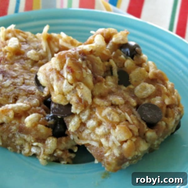 No-Bake Krispie Date Bites 4 Two Almond Butter Rice Krispies Treats on a blue plate, a variation of the date balls.