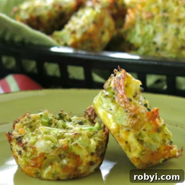 Two golden-brown broccoli cheddar muffins perfectly baked, resting on a white plate with a rustic basket of more muffins blurred in the background, highlighting their appealing texture and savory aroma.