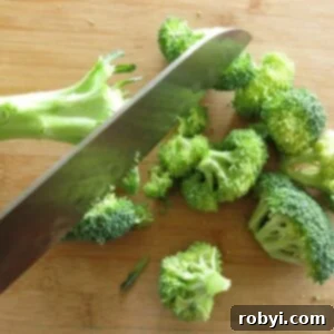 Broccoli florets being cut from stalks.