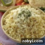 Bowl full of roasted cauliflower rice topped with parmesan cheese and parsley