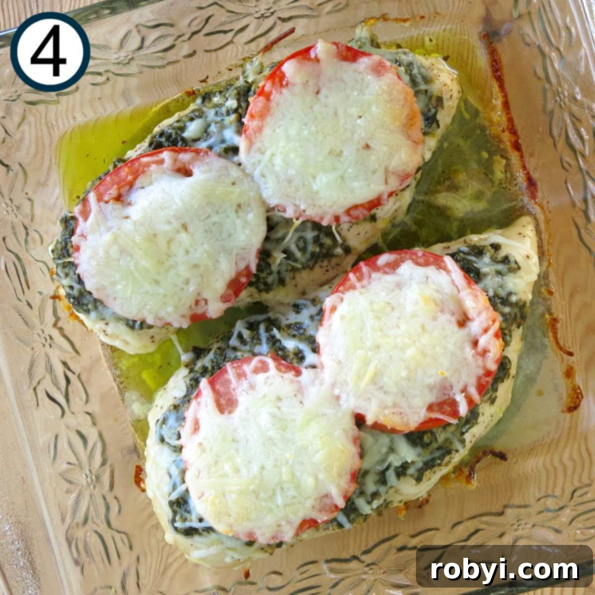 Cooked pesto chicken in a glass baking dish.