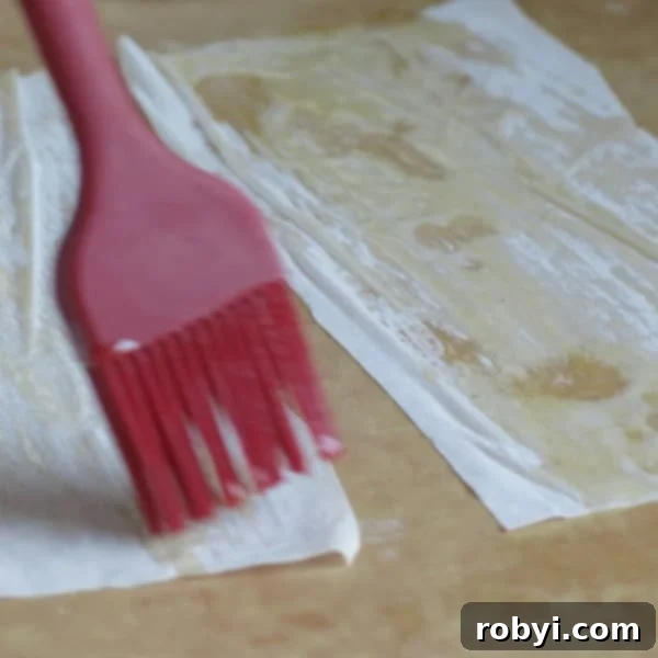 Phyllo Dough being brushed with butter.