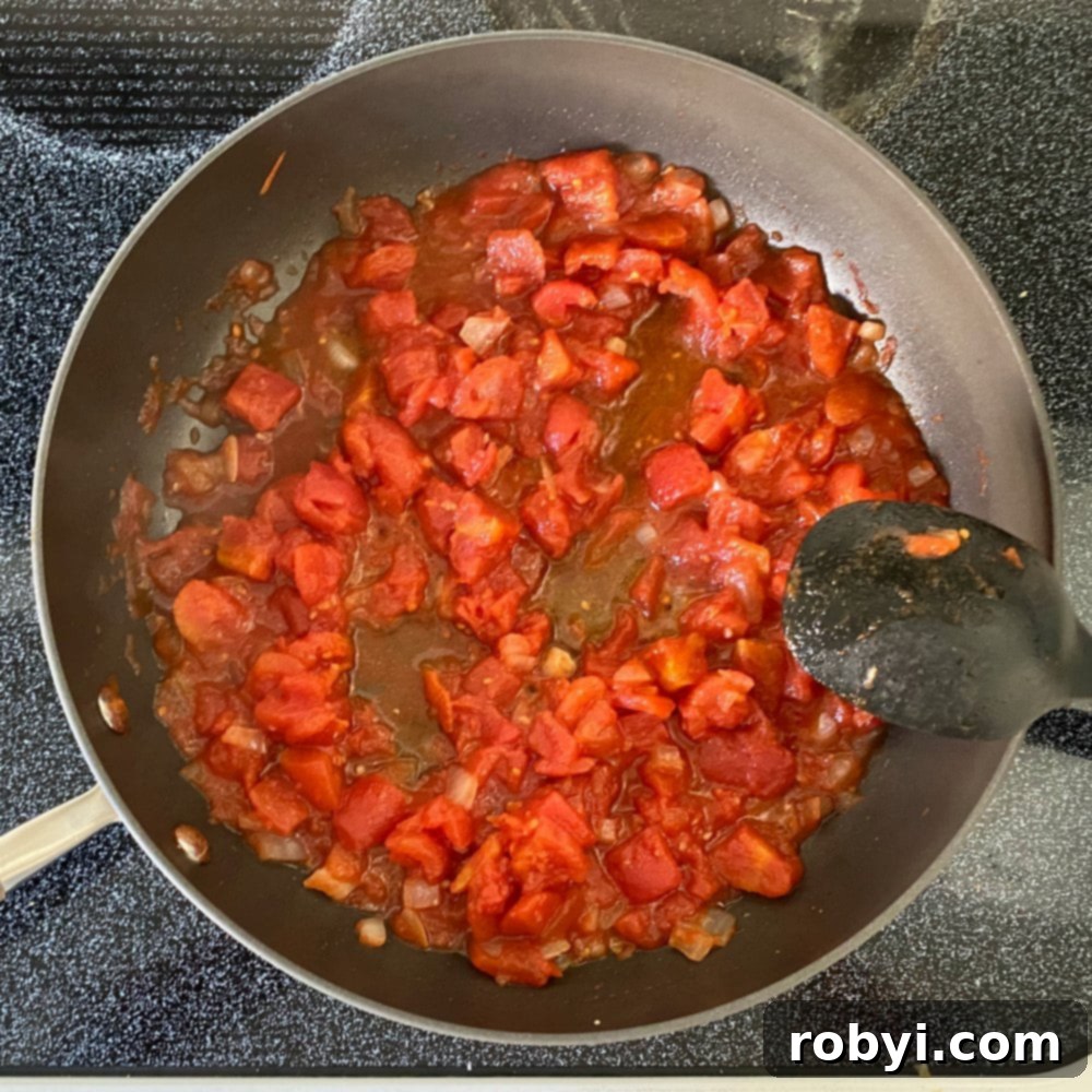 Sizzling Skillet Greek Shrimp with Burst Tomatoes and Crumbled Feta 4 Tomato reduction in a large skillet.
