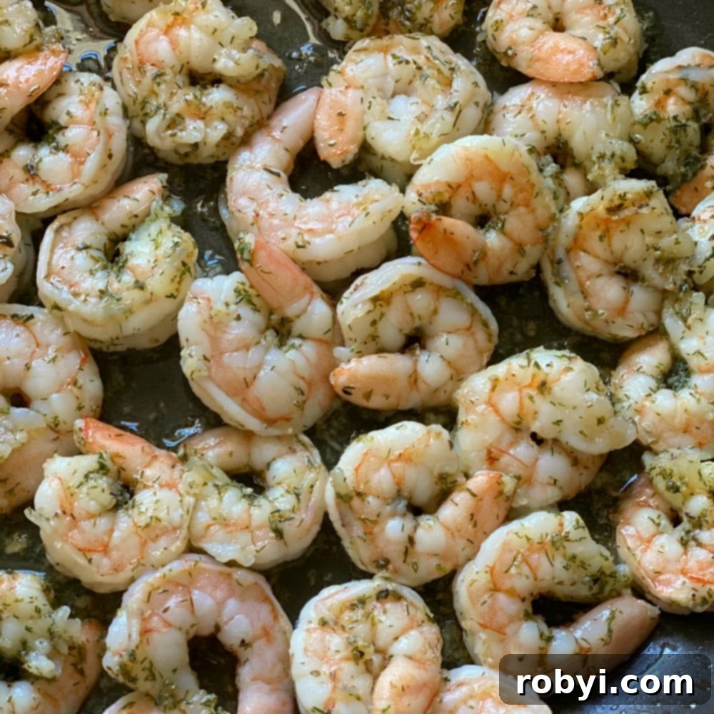 Sizzling Skillet Greek Shrimp with Burst Tomatoes and Crumbled Feta 5 Perfectly cooked Greek shrimp in a skillet.