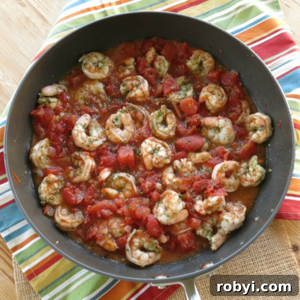 Sizzling Skillet Greek Shrimp with Burst Tomatoes and Crumbled Feta 6 Greek Shrimp and Tomatoes in a skillet.