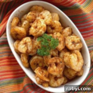 Easy blackened shrimp in a bowl with a sprig of parsley on top.
