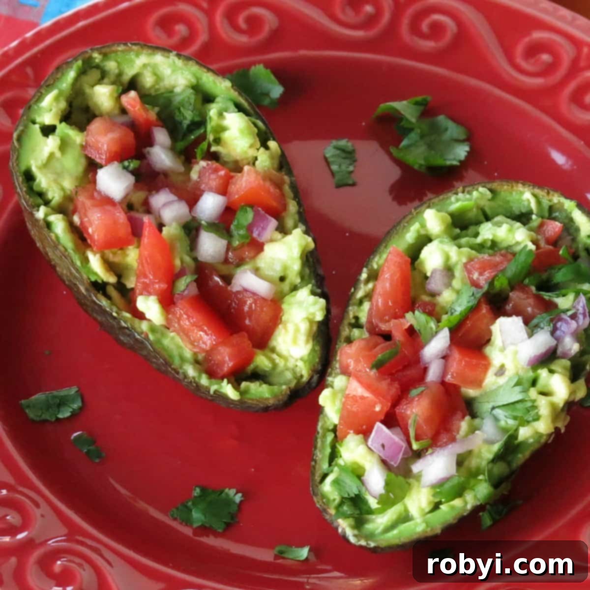 Elevate Your Mornings with Guacamole Toast 3 A perfectly ripe avocado, cut in half, with a generous serving of freshly prepared guacamole nestled in each half, ready to be enjoyed.