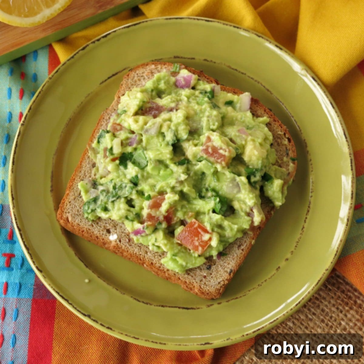 Elevate Your Mornings with Guacamole Toast 4 A freshly made slice of Breakfast Guacamole on Toast, without any additional toppings, showcasing its vibrant green color and inviting texture.