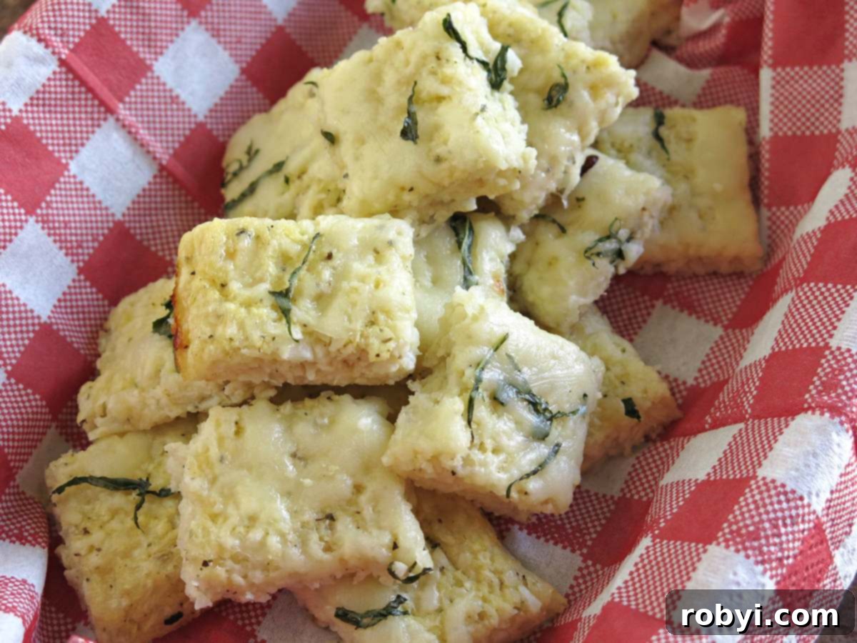 Low-carb cauliflower pizza bites in a basket with a red checkered napkin.
