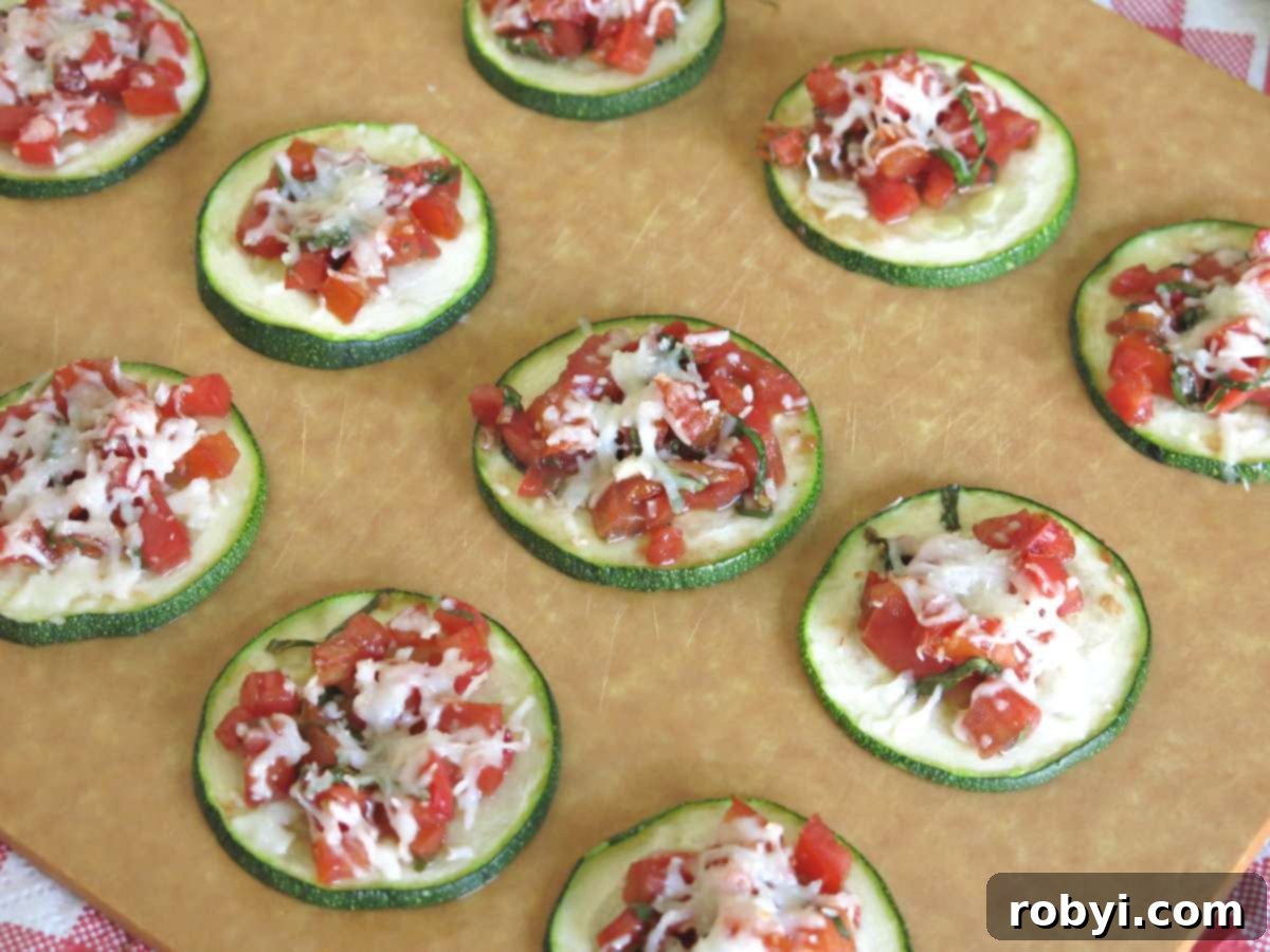Board with lines of zucchini bruschetta on it.