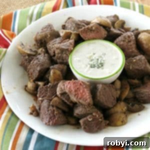 Air Fryer Steak Bites on plate with mushrooms and blue cheese dipping sauce