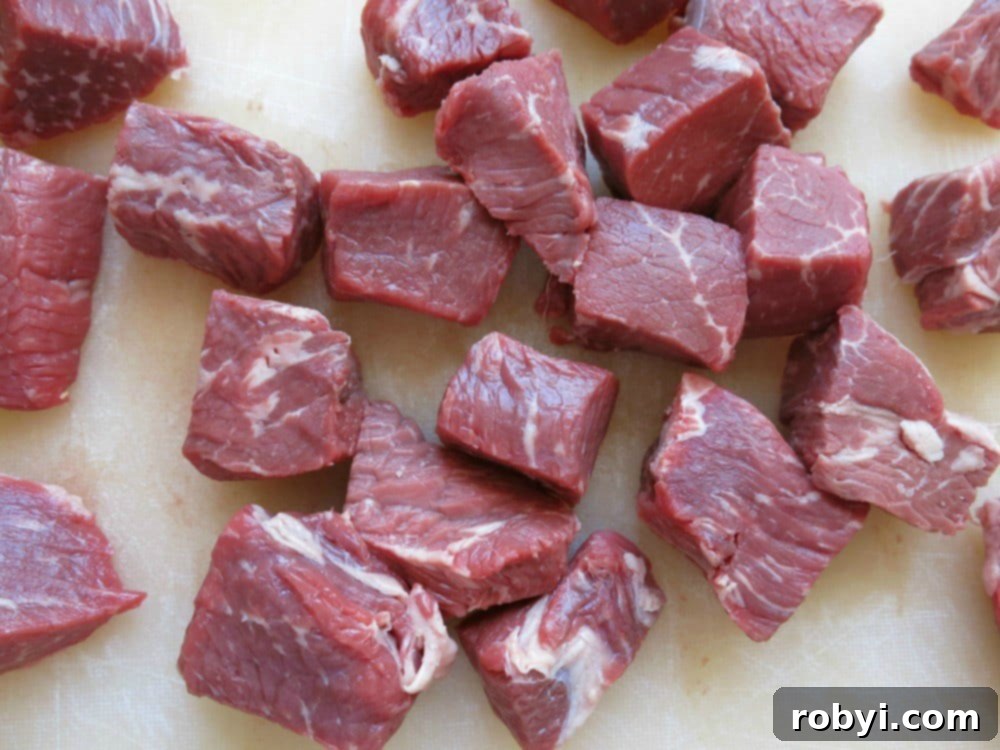 Cubed sirloin steak filets neatly arranged on a cutting board.