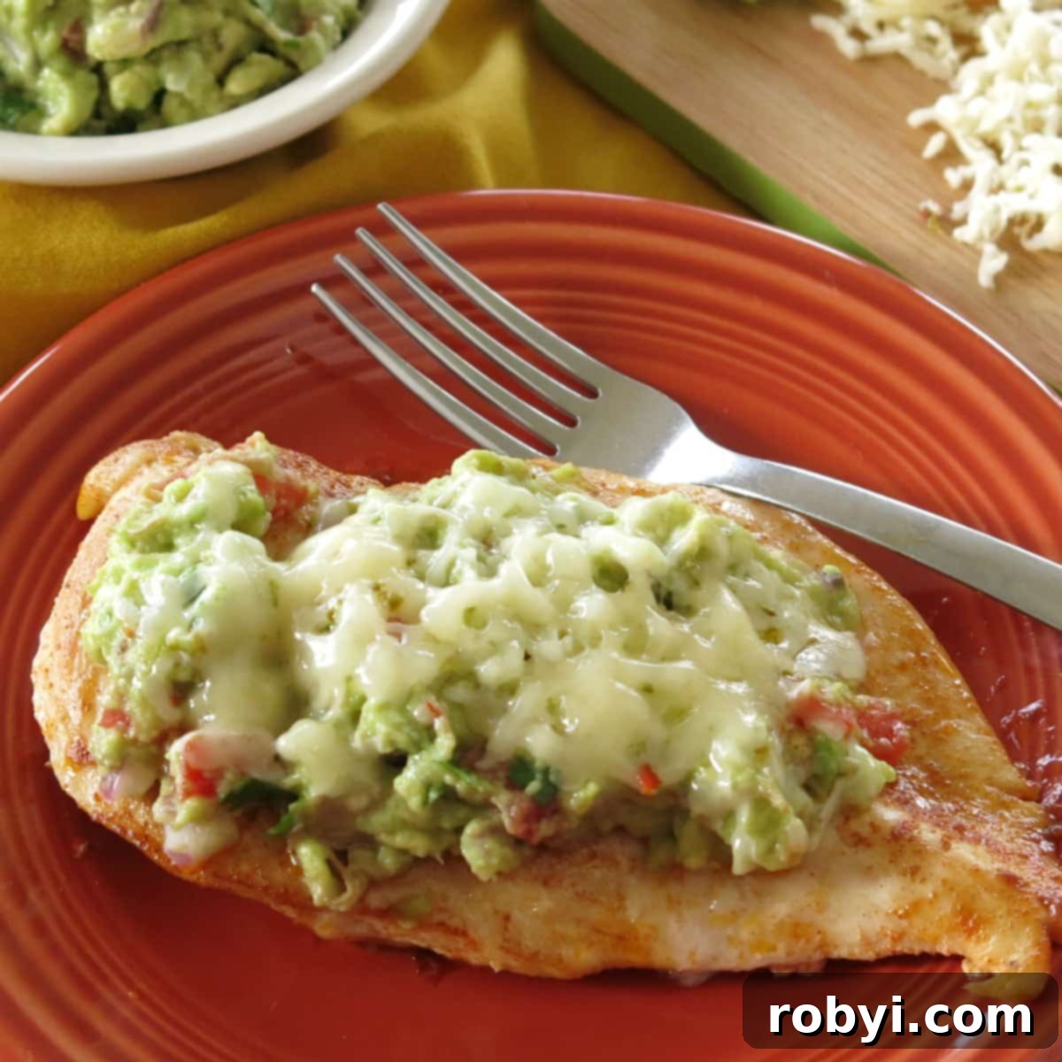Guacamole Chicken on a plate with fork.