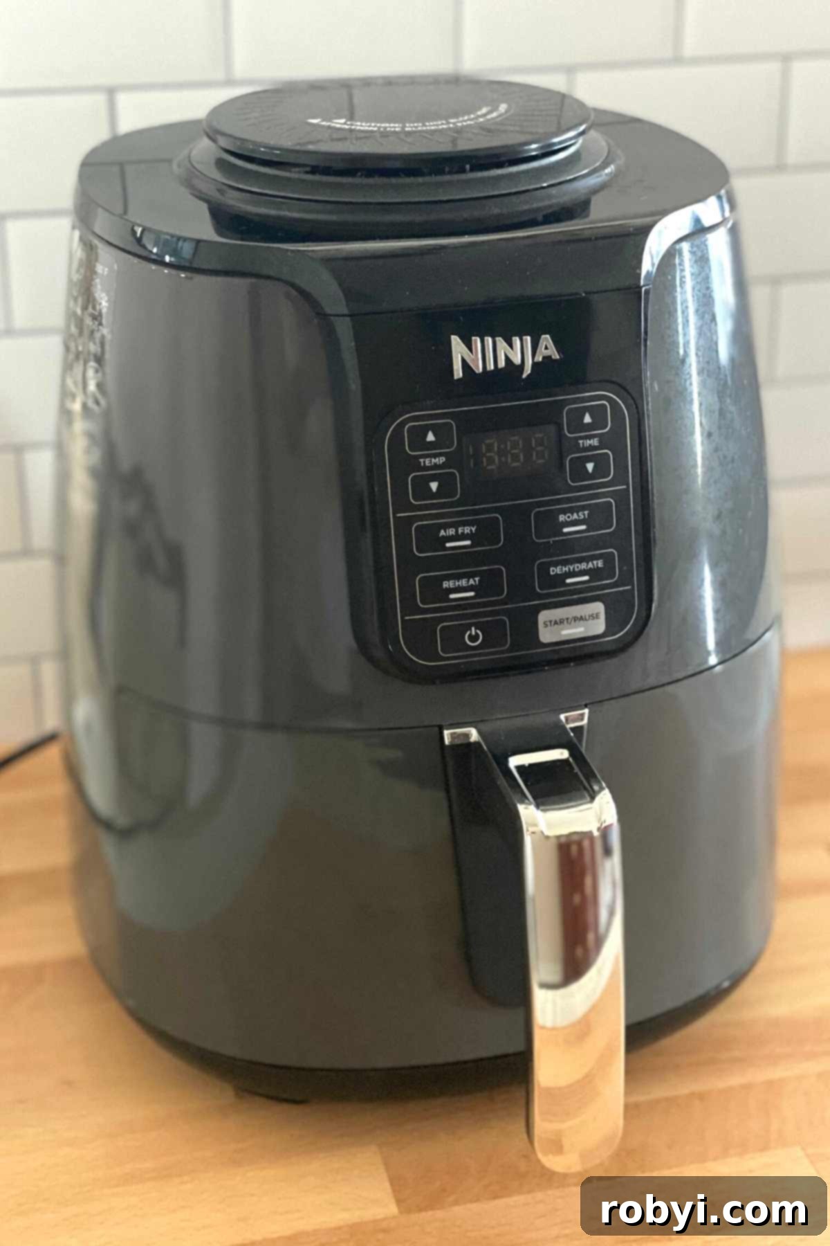 Easy Air Fryer Hard Boiled Eggs for All Models 3 A 4-quart Ninja air fryer positioned neatly on a kitchen counter, ready for use.