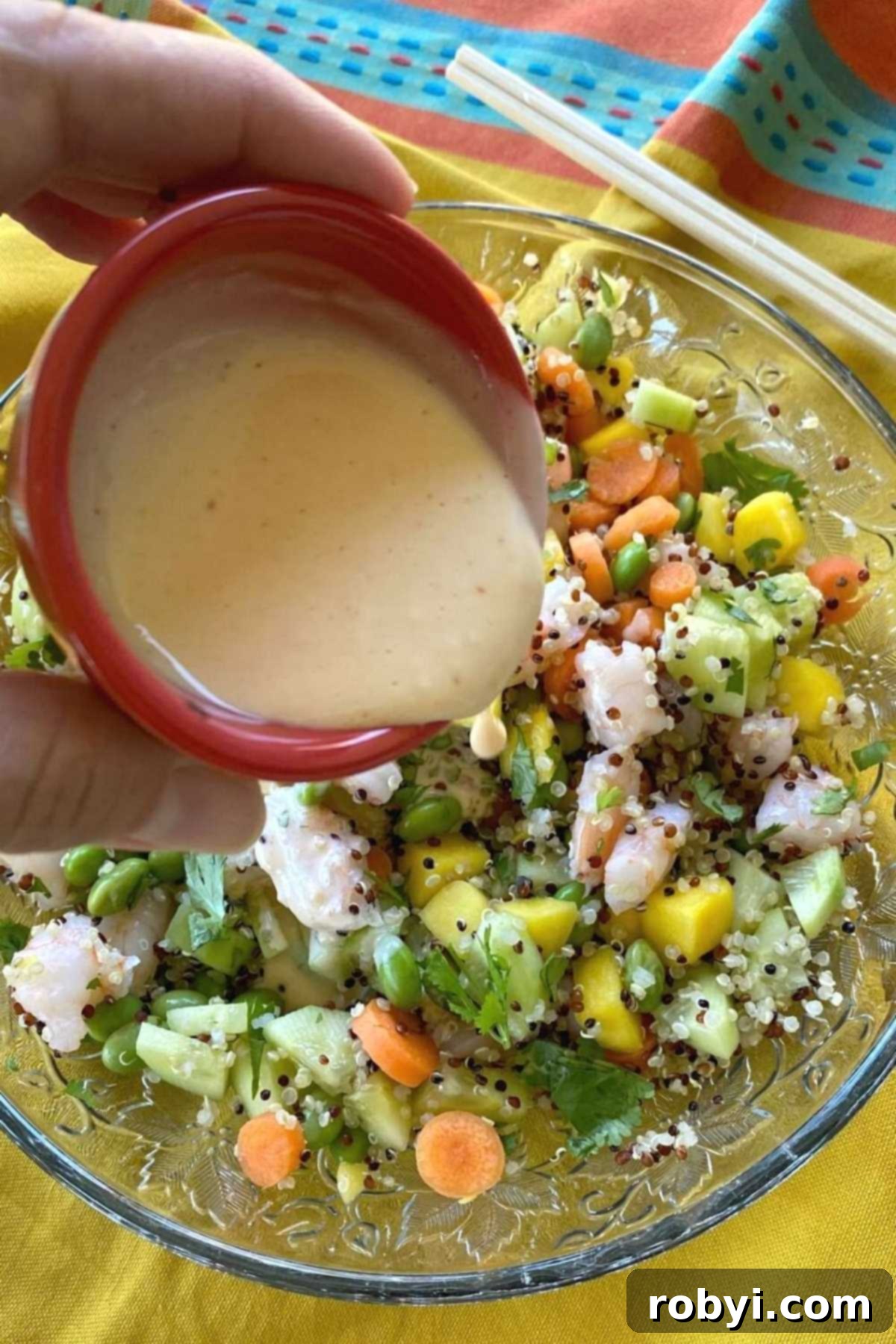 Creamy poke sauce being drizzled generously over a perfectly assembled Shrimp Poke Bowl, ready to be enjoyed.
