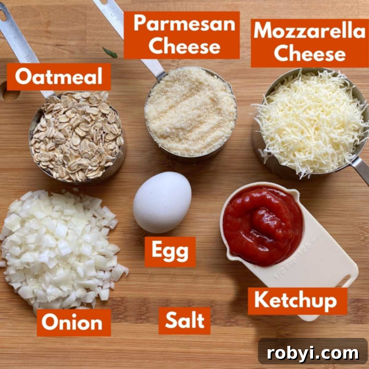 Labeled ingredients for ground chicken meatloaf: oatmeal, Parmesan cheese, mozzarella cheese, diced onion, egg, ketchup, and salt, ready to be mixed.