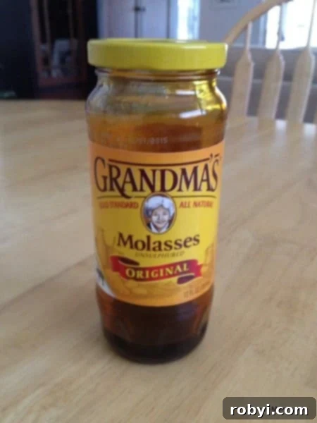 A jar of Grandma's Original Molasses on a light background, ready for making marinade.