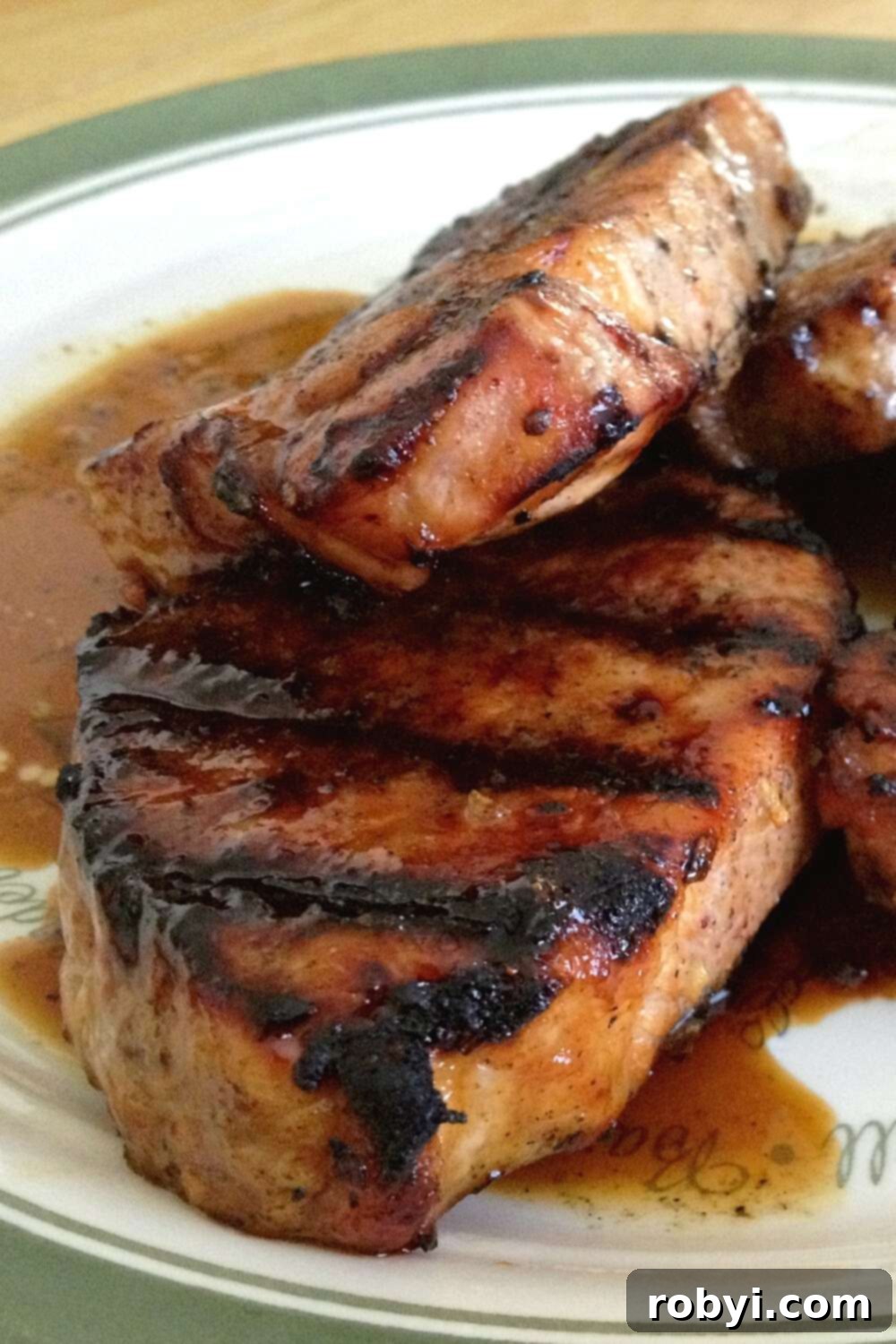 Close-up of a grilled pork chop with a sweet molasses glaze, ready to be served.