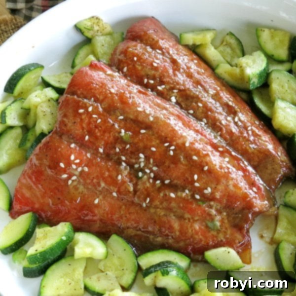 Delectable Bourbon Salmon served alongside tender roasted zucchini, arranged artfully in a serving dish.