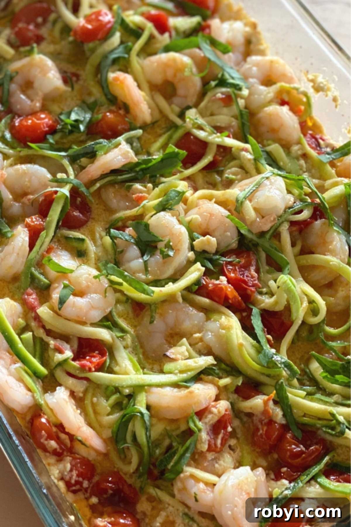 Creamy Baked Feta Shrimp with Zucchini Noodles 5 Finished recipe in a glass baking dish.