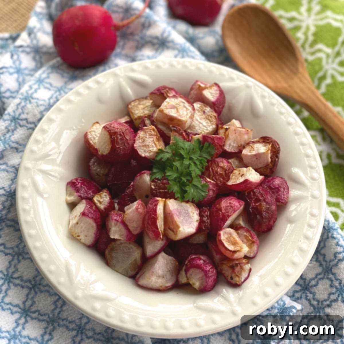 Air fried radishes in a bowl with wooden spoon next to it.