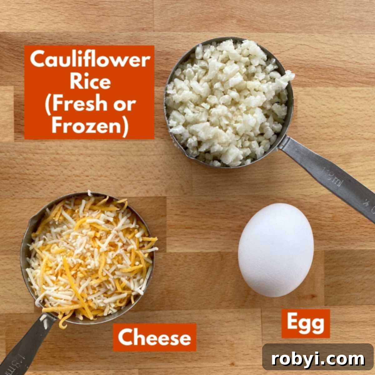 Simple Three Ingredient Cauliflower Chaffles 3 Ingredients to make recipe: cauliflower rice, egg and shredded cheese on cutting board.